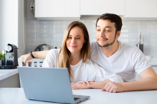 Two adults looking at a laptop